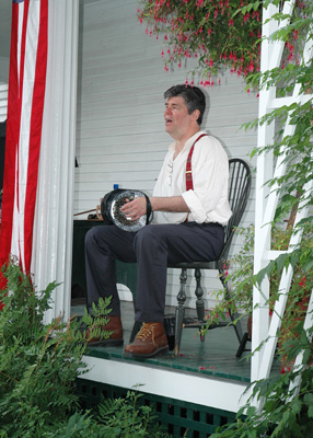 Jeff and concertina on Goodwin Mansion porch, July 4th 2006
